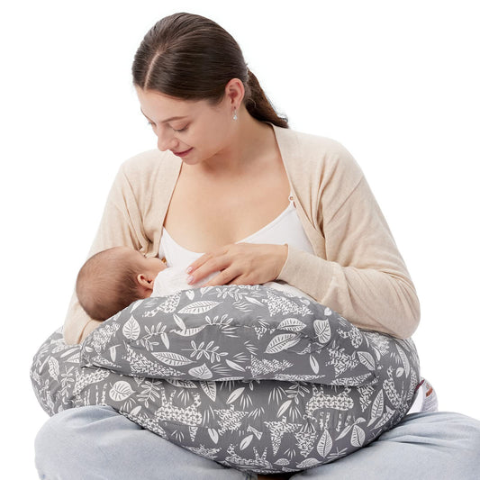 "Mother sitting on the floor using a multifunctional nursing pillow to comfortably support her baby during breastfeeding."
