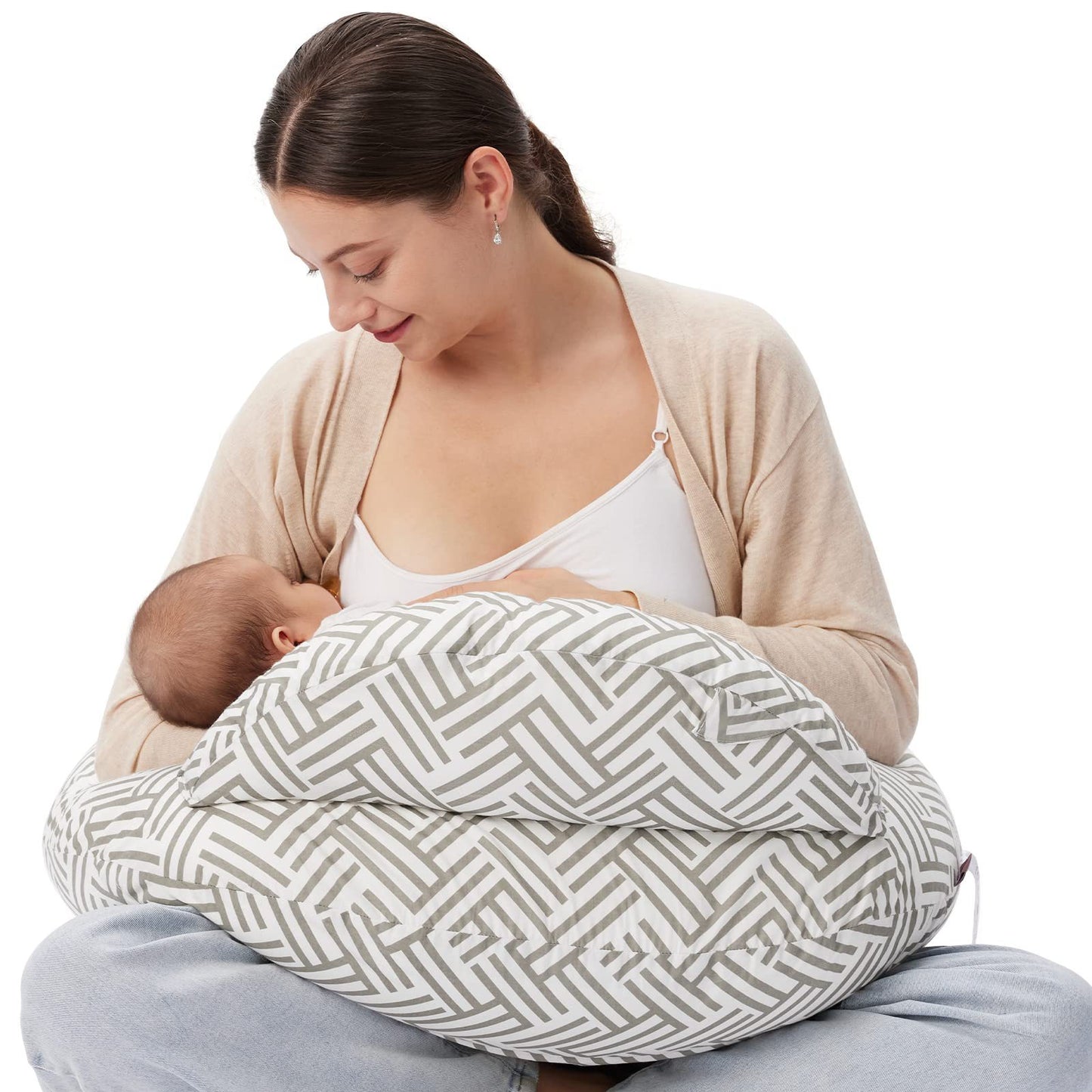 "Mother seated on the floor using a multifunctional nursing pillow to comfortably cradle her baby for breastfeeding support."
