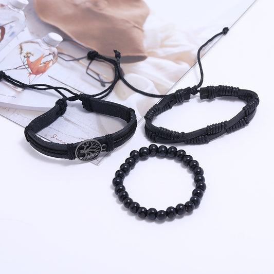 Three black braided leather bracelets with Tree of Life charm on a clean white background – unisex adjustable wristwear