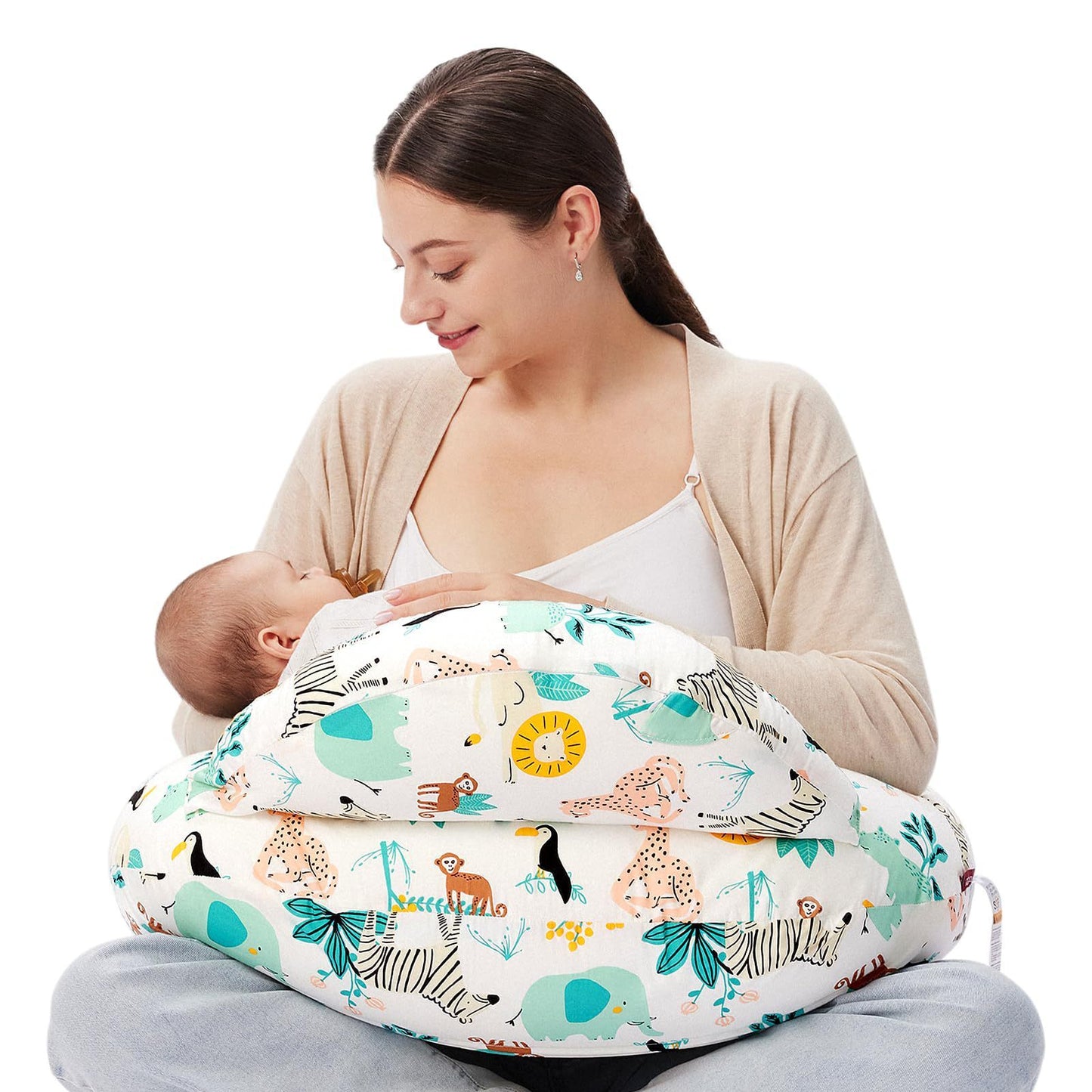 "Mother seated on the floor using a multifunctional nursing pillow to comfortably cradle her baby for breastfeeding support."