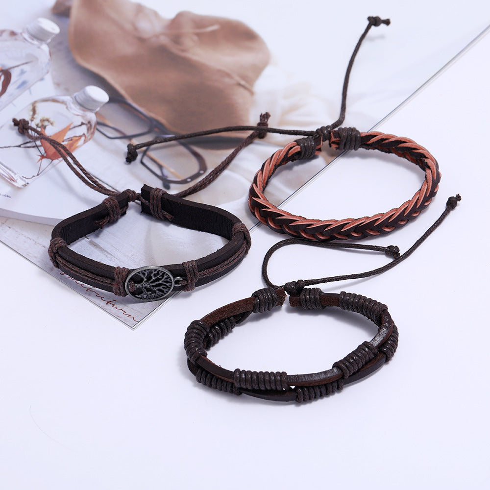 
Three braided leather bracelets displayed on a white surface with a blurred natural background – unisex adjustable set


