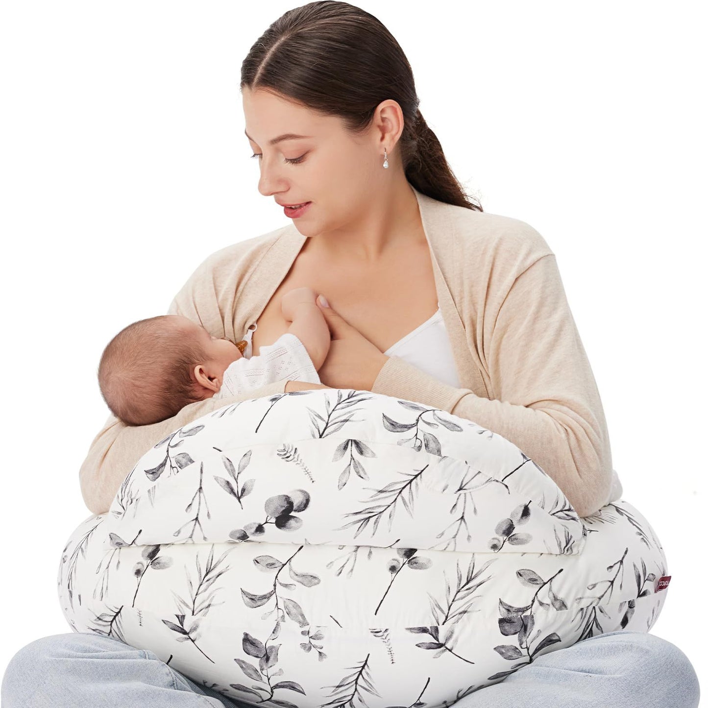 
"Mother seated on the floor using a multifunctional nursing pillow to comfortably cradle her baby for breastfeeding support."