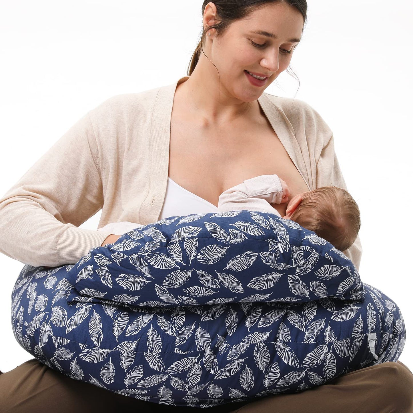 
"Mother sitting on the floor using a multifunctional nursing pillow to comfortably support her baby during breastfeeding."