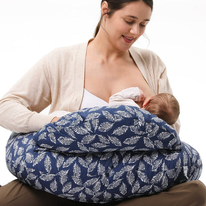 
"Mother sitting on the floor using a multifunctional nursing pillow to comfortably support her baby during breastfeeding."
