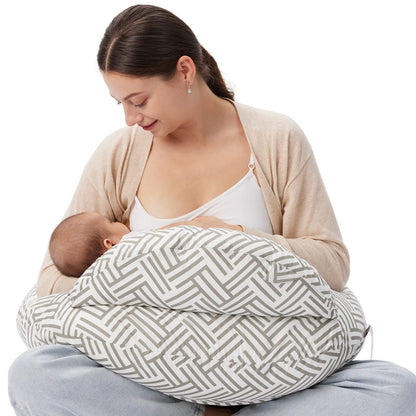 
"Mother seated on the floor using a multifunctional nursing pillow to comfortably cradle her baby for breastfeeding support."