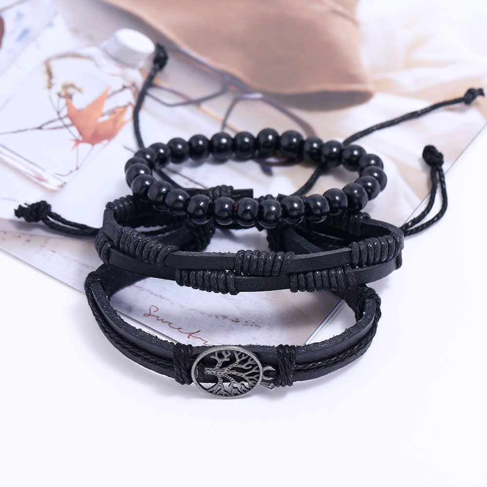 
Set of black beaded bracelets with Tree of Life charm on white background – unisex spiritual leather accessory