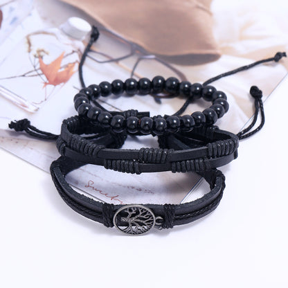 
Set of black beaded bracelets with Tree of Life charm on white background – unisex spiritual leather accessory
