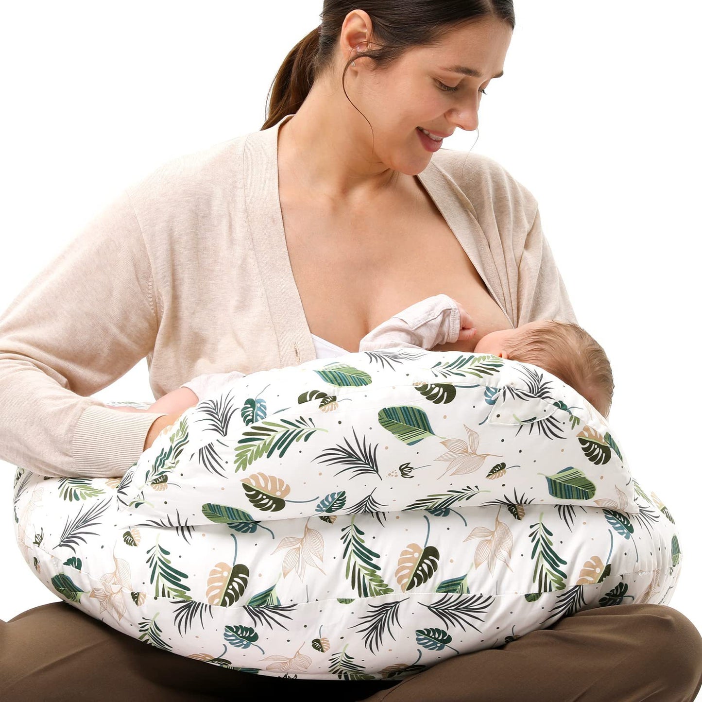 
"Mother seated on the floor using a multifunctional nursing pillow to comfortably cradle her baby for breastfeeding support."