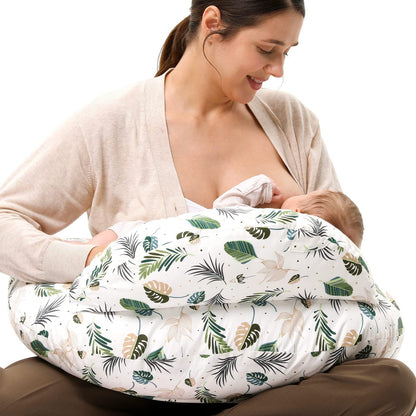 
"Mother seated on the floor using a multifunctional nursing pillow to comfortably cradle her baby for breastfeeding support."