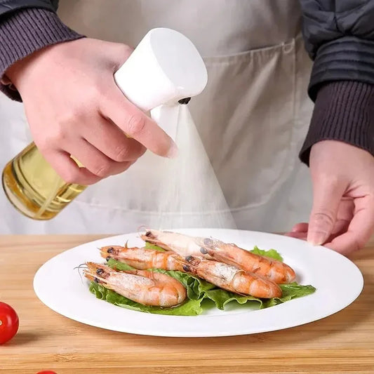 "Person wearing an apron seasoning shrimp on a plate using an oil spray bottle, highlighting hands-on cooking preparation."