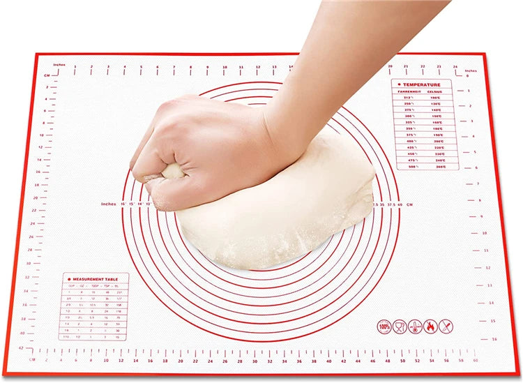 
"Silicone baking mat with measurement markings, shown with a hand holding dough ready for rolling."

