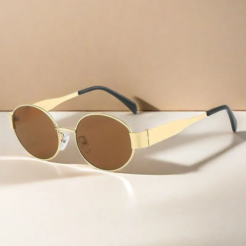 Gold-framed sunglasses with brown lenses on a beige background