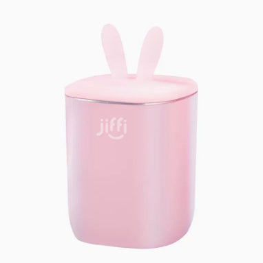 
"Pink container with bunny ear design and 'jiffi' branding, placed on a clean white background, suitable for baby snacks or storage."