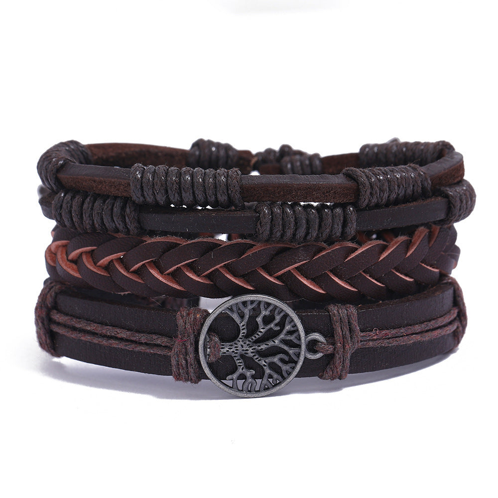 
Stack of brown leather bracelets with central metal Tree of Life charm on white background – unisex boho accessory