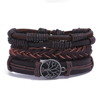 
Stack of brown leather bracelets with central metal Tree of Life charm on white background – unisex boho accessory